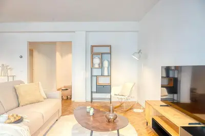 a living room with a couch and a table at Ample 2-BR Apt in Antwerp in Antwerp