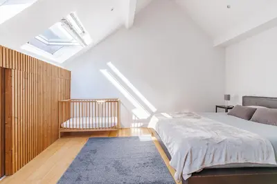 a bedroom with a bed and a skylight at Le Havre de Lumière à Etterbeek in Brussels