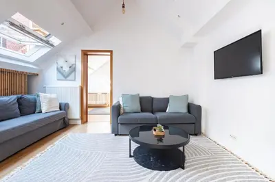 a living room with a couch and a table at Le Havre de Lumière à Etterbeek in Brussels