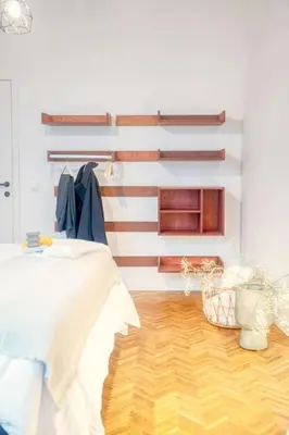 a room with a bed and a wooden floor at 2-BR Haven in Antwerp in Antwerp