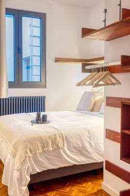 a bedroom with a white bed and a window at 2-BR Haven in Antwerp in Antwerp