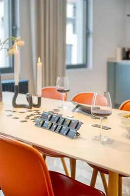 a table with two glasses of wine on it at 2-BR Haven in Antwerp in Antwerp