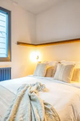 a bedroom with a white bed with a blanket on it at Unique 2-BR Antwerp Apt in Antwerp