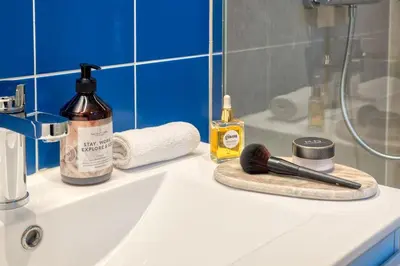 a bathroom counter with a sink with a brush on it at Unique 2-BR Antwerp Apt in Antwerp