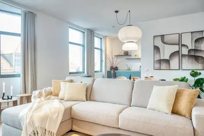 a living room with a white couch in a room at Unique 2-BR Antwerp Apt in Antwerp