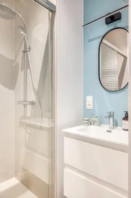 a bathroom with a shower and a sink and a mirror at Unique 2-BR Antwerp Apt in Antwerp