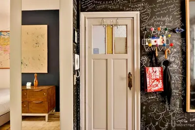 a room with a door and a wall with writing on it at B'Kanal in Brussels
