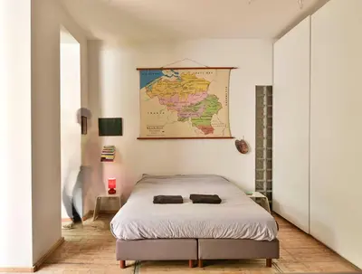 a bedroom with a bed and a map on the wall at B'Kanal in Brussels