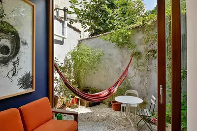 a patio with a hammock and a table and chairs at B'Kanal in Brussels