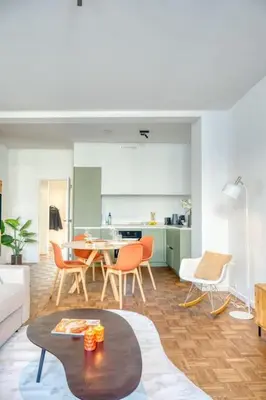 a large living room with a table and chairs at Cozy Retreat in Antwerp with balcony in Antwerp