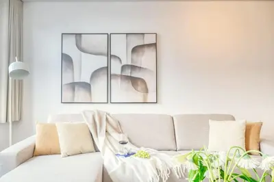 a living room with a couch and a picture on the wall at Cozy Retreat in Antwerp with balcony in Antwerp
