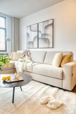 a living room with a white couch and a table at Magical renovated home in Antwerp in Antwerp