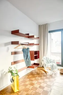 a living room with a wooden wall and a chair at Magical renovated home in Antwerp in Antwerp