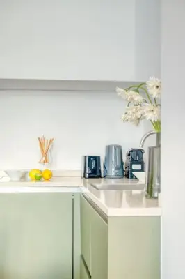 a kitchen with two sinks and a coffee maker at Magical renovated home in Antwerp in Antwerp