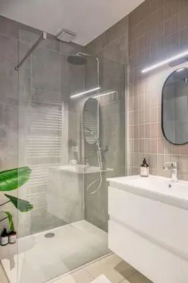 a bathroom with a shower and a tub and a sink at Magical renovated home in Antwerp in Antwerp