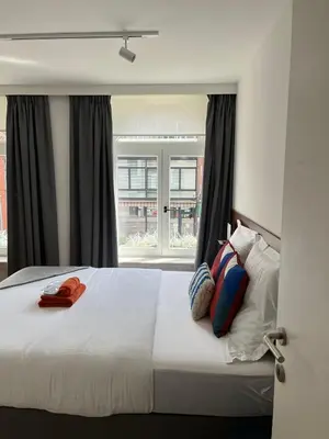 a bedroom with a bed with a red phone on it at Business Accommodation 'Eclectic Living' Nomad in Geel
