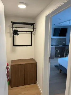 a room with a closet and a bed and a door at Business Accommodation 'Eclectic Living' Nomad in Geel