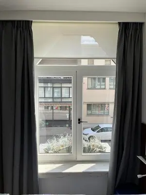 a window with a view of a building at Business Accommodation 'Eclectic Living' Nomad in Geel