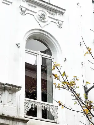 a window on a white building with an ornate trim at Mansion RL with Unique Decoration in Antwerp