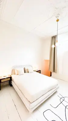 a white bedroom with a large bed and a window at Mansion RL with Unique Decoration in Antwerp