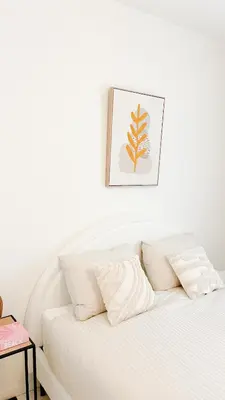 a white bed with white pillows and a picture on the wall at Mansion RL with Unique Decoration in Antwerp