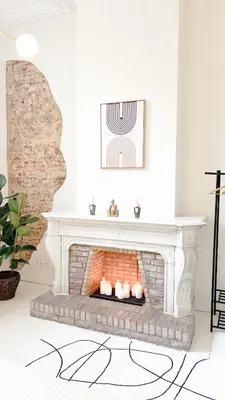 a fireplace in a living room with a brick wall at Mansion RL with Unique Decoration in Antwerp