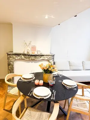 a dining room with a black table and chairs at Mayfair Suites in Antwerp