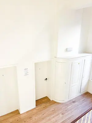 a bathroom with white cabinets and a sink at Mayfair Suites in Antwerp
