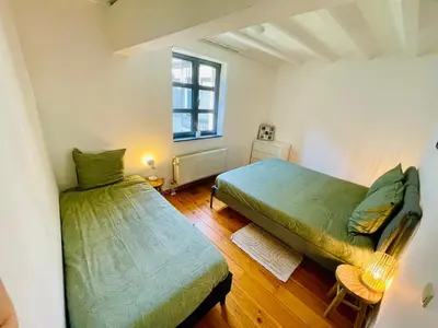 a bedroom with two beds and a window at Oasis-Spacious Loft in Excellent Location in Brussels
