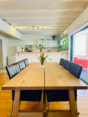 a wooden table with chairs and a dining room at Oasis-Spacious Loft in Excellent Location in Brussels