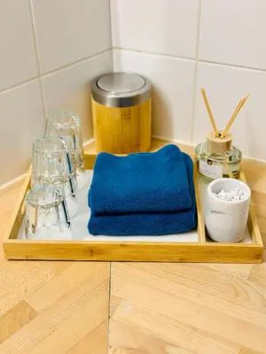 a wooden tray with a blue towel and other items on a counter at Oasis-Spacious Loft in Excellent Location in Brussels