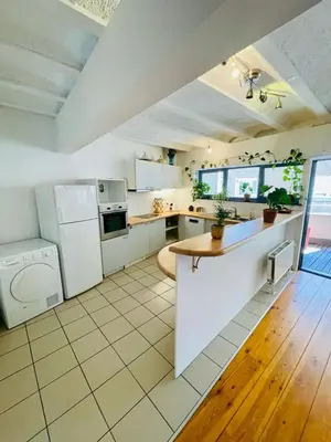 a kitchen with white appliances and a tile floor at Oasis-Spacious Loft in Excellent Location in Brussels