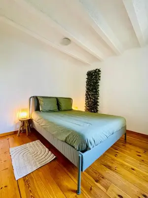 a bedroom with a bed in a room with wooden floors at Oasis-Spacious Loft in Excellent Location in Brussels