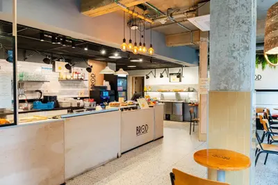 a large kitchen with tables and chairs in a restaurant at Citybox Brussels Centre Louise in Brussels