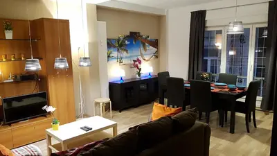 a living room with a couch and a dining room at Apartment Chez Esmara et Philippe in Brussels