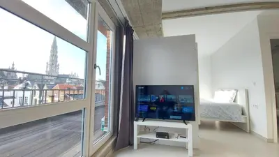 a bedroom with a large window with a view of the eiffel tower at Apartment Chez Esmara et Philippe in Brussels