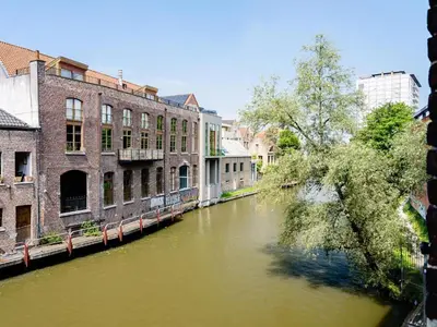 a view of a river in a city with buildings at Budget Rooms by Ghent River in Ghent