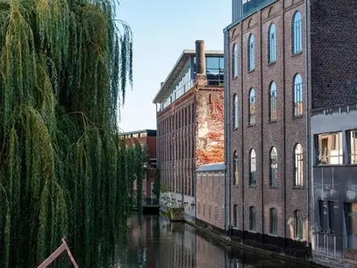 a group of buildings and a canal in a city at Budget Rooms by Ghent River in Ghent
