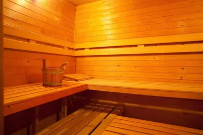 a wooden sauna with a bucket on the back of it at Budget Rooms by Ghent River in Ghent