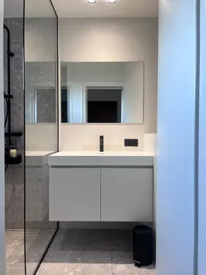 a bathroom with a white sink and a mirror at Cosy apartment for 2p-4p Ghent in Ghent