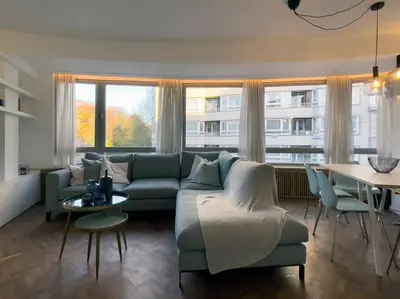 a living room with a couch and a table at Cosy apartment for 2p-4p Ghent in Ghent