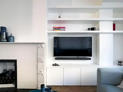 a living room with a tv and a fireplace at Cosy apartment for 2p-4p Ghent in Ghent