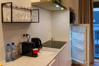 a kitchen with a counter top with a refrigerator at Pacific Residences - Studio in Antwerp