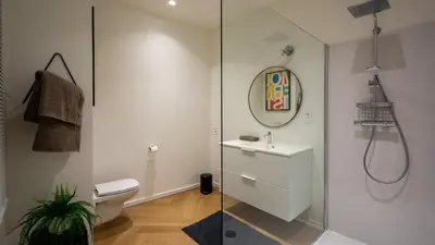 a bathroom with a toilet and a sink and a mirror at Pacific Residences - Studio in Antwerp