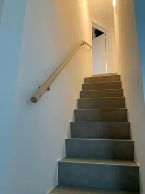 a staircase in a building with a stair case at Appartement séparé avec parking dans villa in Vilvoorde