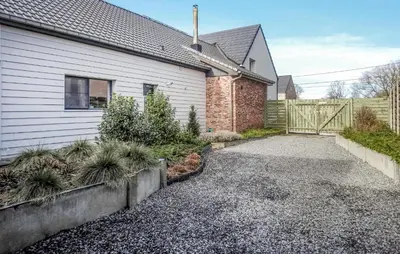 a house with a driveway next to a fence at 2 Bedroom Beautiful Home In Herselt in Herselt