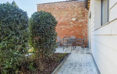 a patio with two trees and a table and chairs at 2 Bedroom Beautiful Home In Herselt in Herselt