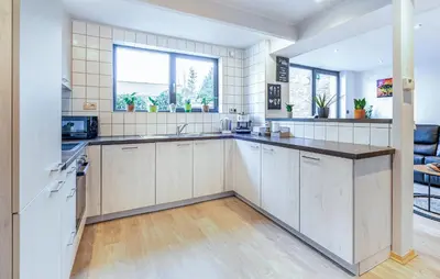 an open kitchen with white cabinets and a large window at 2 Bedroom Beautiful Home In Herselt in Herselt