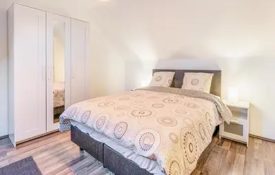 a bedroom with a bed with a pink bedspread at 2 Bedroom Beautiful Home In Herselt in Herselt