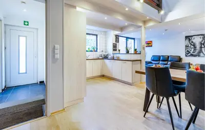 a kitchen and dining room with a table and chairs at 2 Bedroom Beautiful Home In Herselt in Herselt